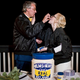 Newlywed couple in front of a "Helms & Mayo" mayonnaise jar wedding cake